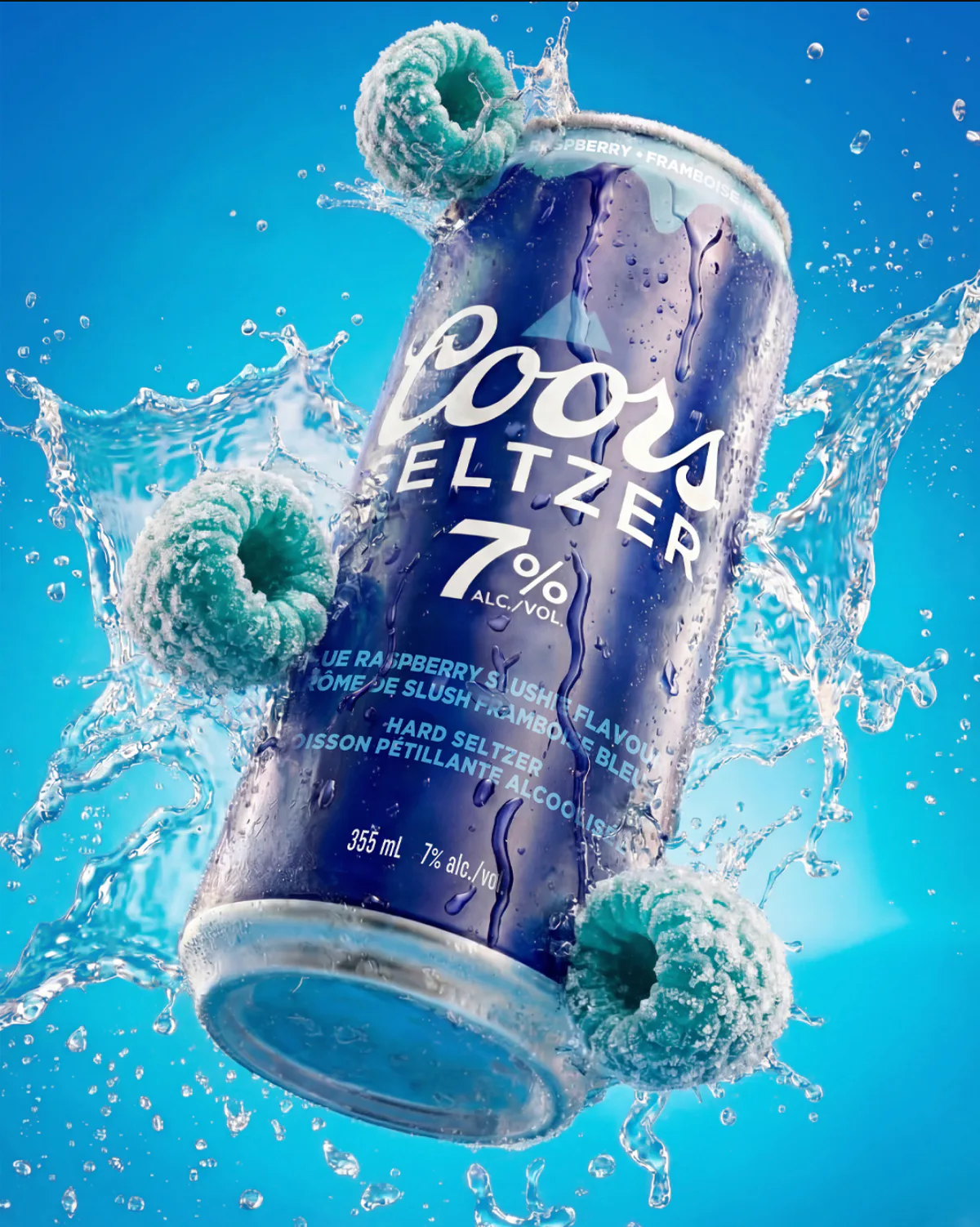 Coors Seltzer Blue Raspberry can with frozen raspberries and water splash