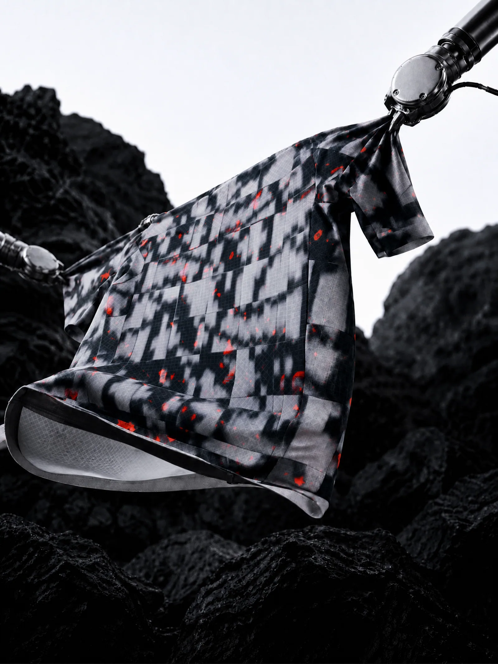 TheOneOff technical garment held by robotic arms in a dark synthetic landscape