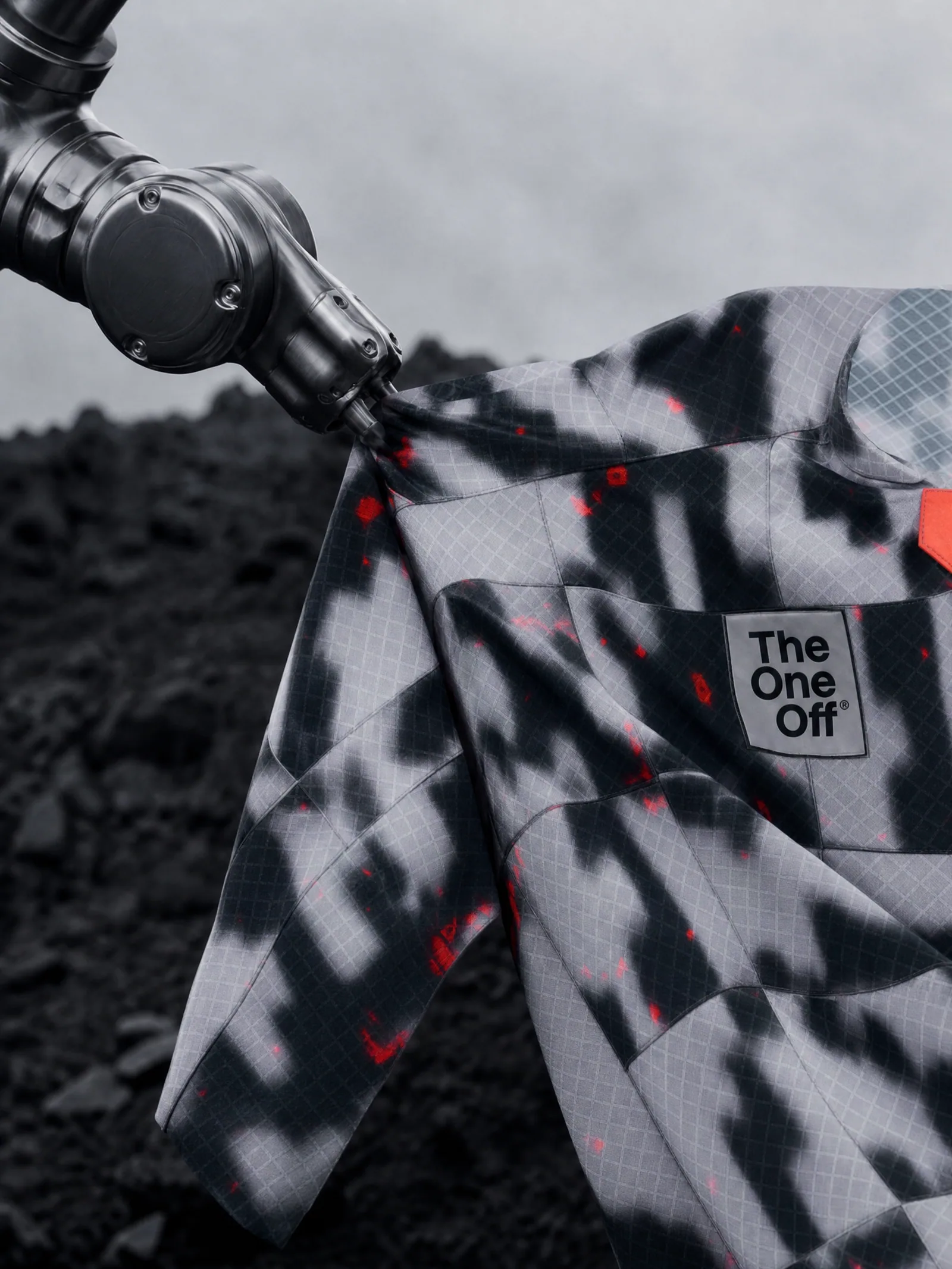 Robotic arm holding a technical TheOneOff garment for the Gobik Wear campaign