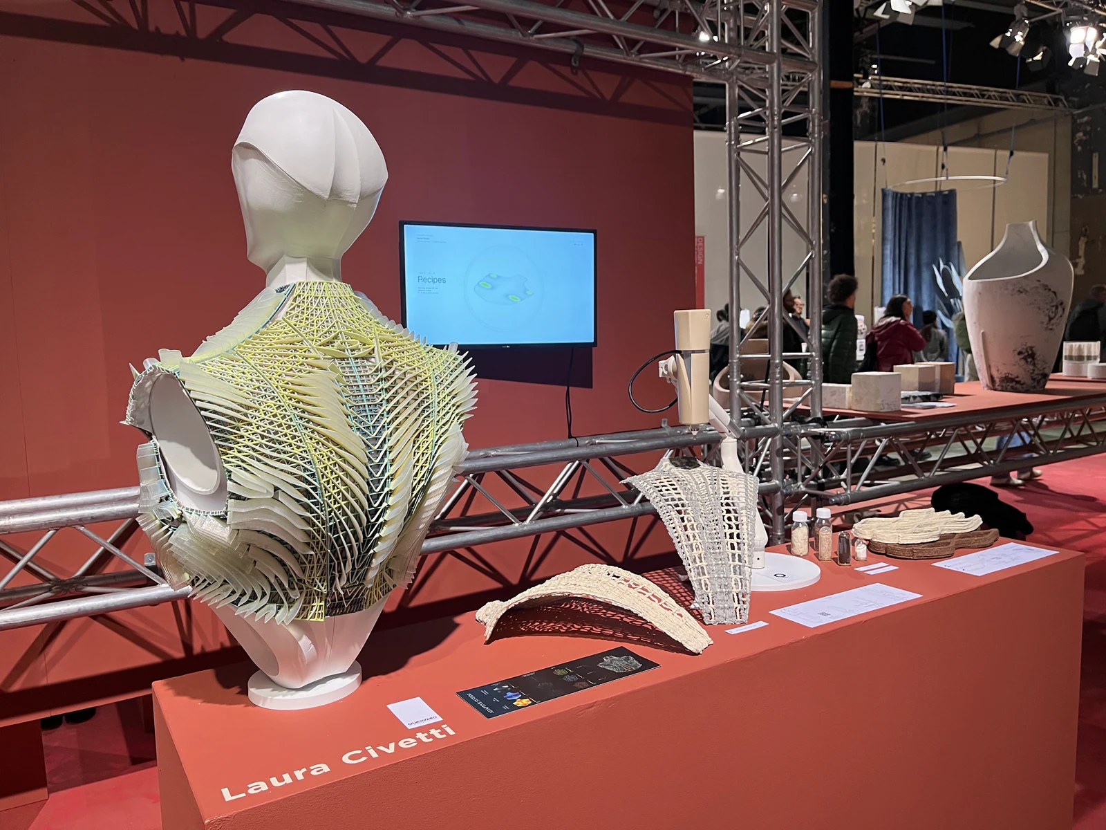 The physical Adaptive System garment and material samples on Laura Civetti's exhibition plinth at Dutch Design Week in Eindhoven
