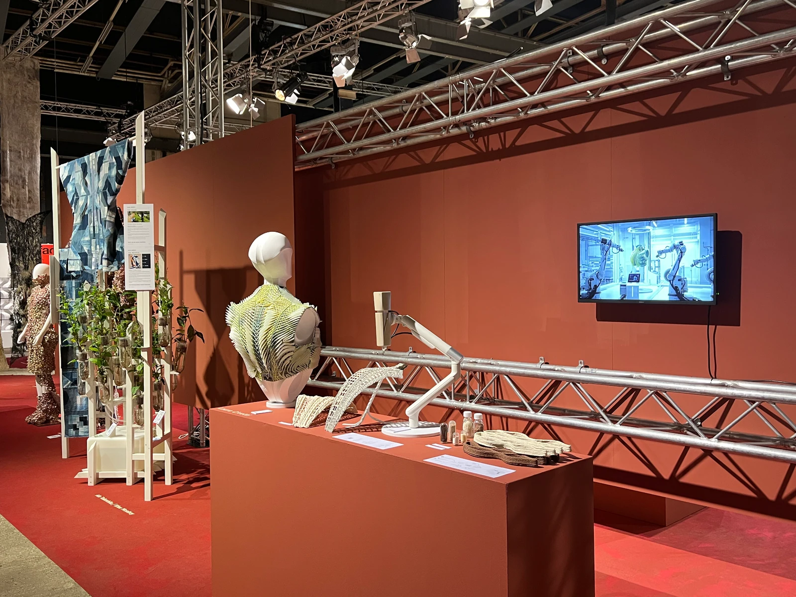 Laura Civetti's Adaptive System installation at Dutch Design Week 2026, with the SSH film playing beside the garment and material research
