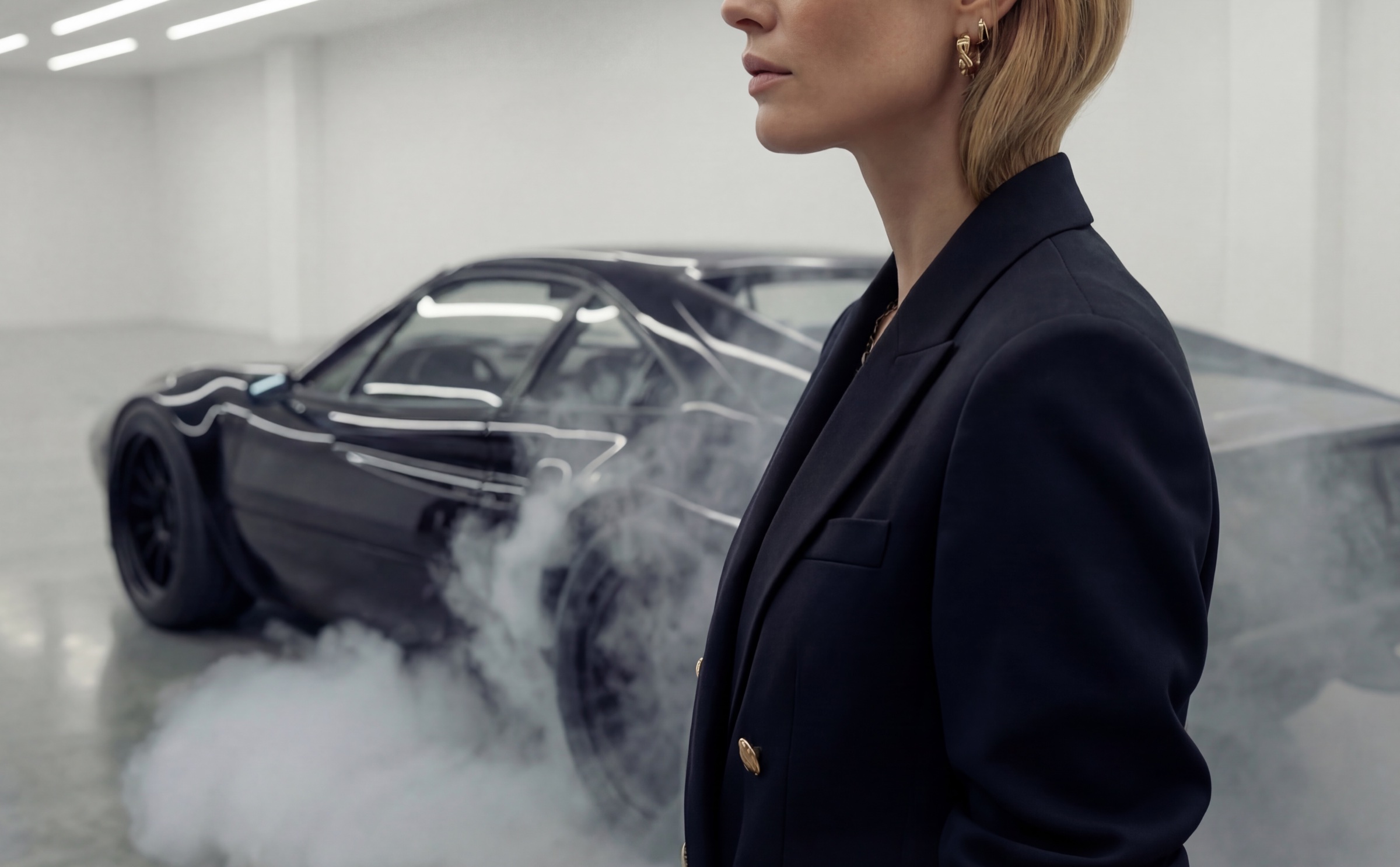 Marks and Spencer and Silverstone Circuit campaign cover with tailored look beside a car in a smoke-filled setting