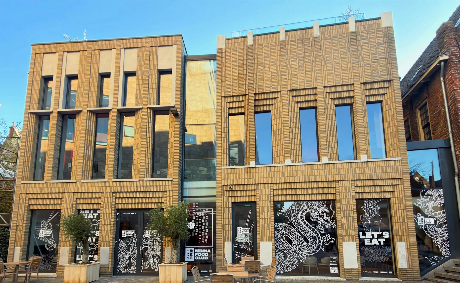Minna Foodclub façade in Groningen with illustrated branding across the windows