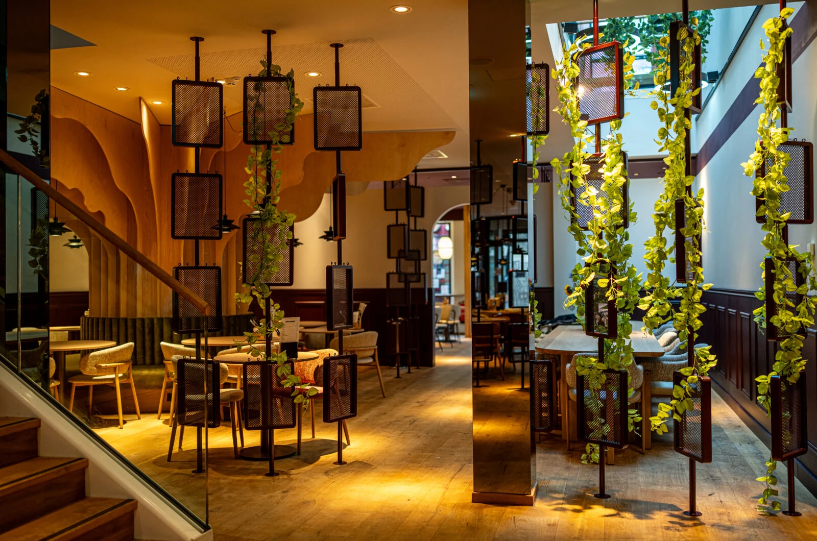 Minna Foodclub restaurant interior with suspended frames and planting