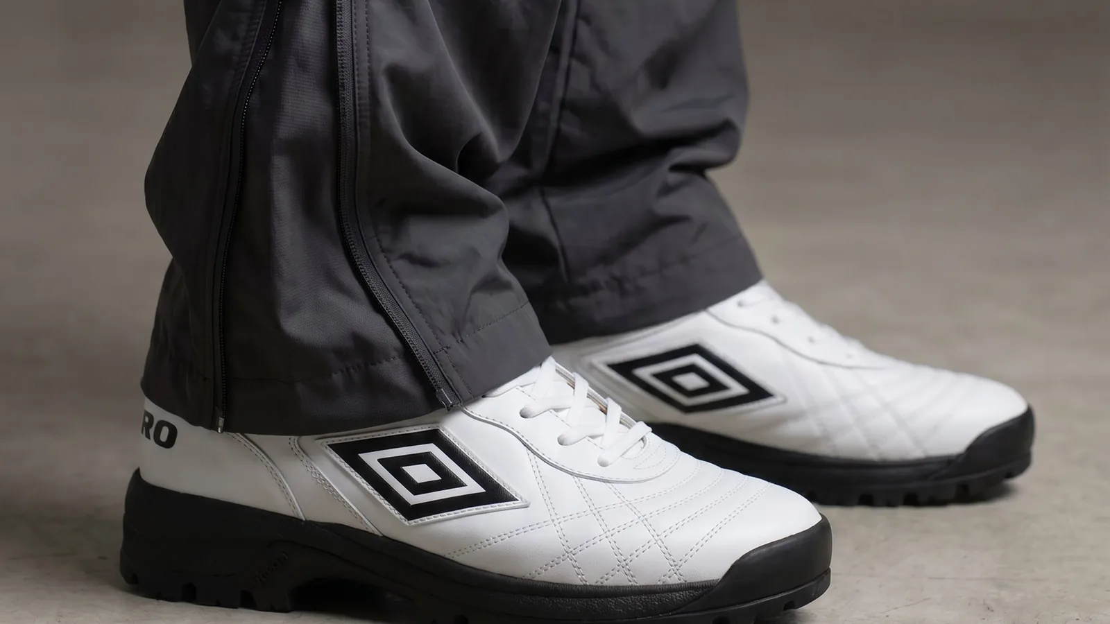 White Umbro SS27 footwear styled with technical black trousers
