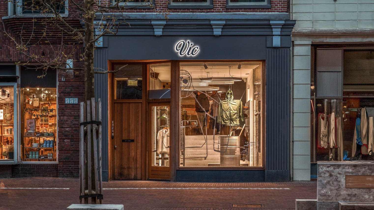 VIC menswear storefront with the renewed illuminated logo in Groningen