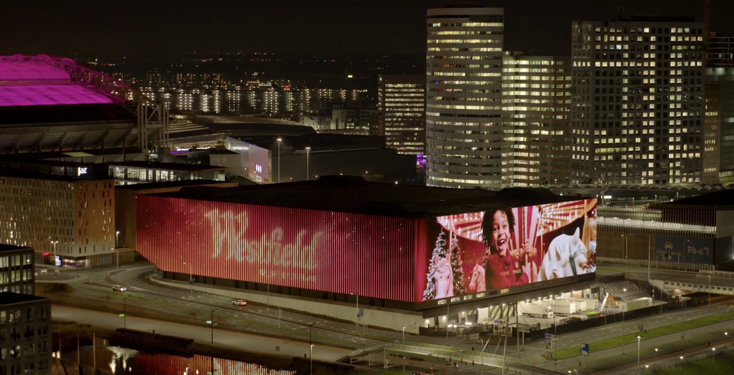 Westfield Malls campaign cover showing a large illuminated mall facade and city skyline at night